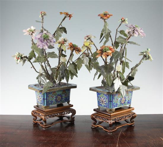 A pair of Chinese hardstone models of flowers with cloisonne enamel jardinieres, early 20th century, total height 39.5cm and 40.5cm, so